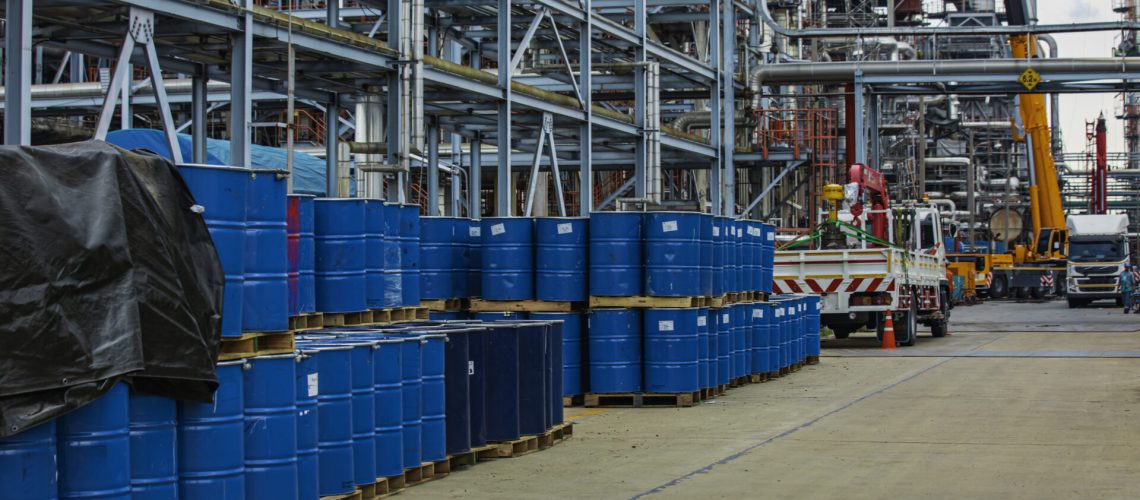 Barrels stock chemical products The metal barrels are blue. Oil​ refinery​ night plant and tower of Petrochemistry industry.